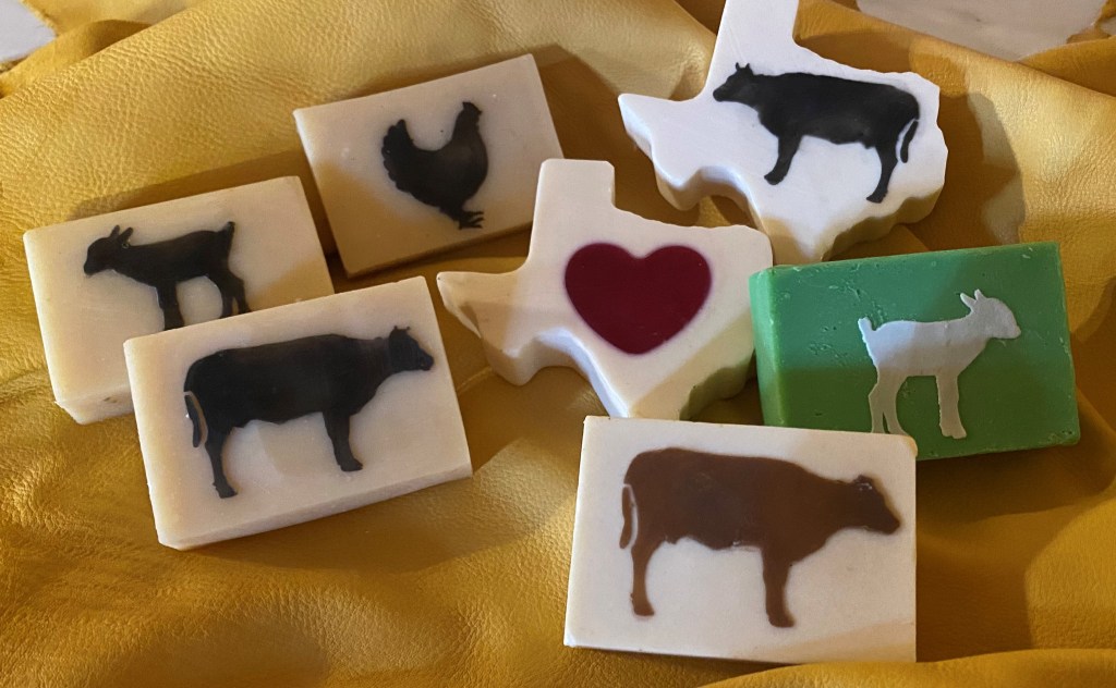 picture of goats milk soap with animals on front of soap a Texas shape soap with a hear in it