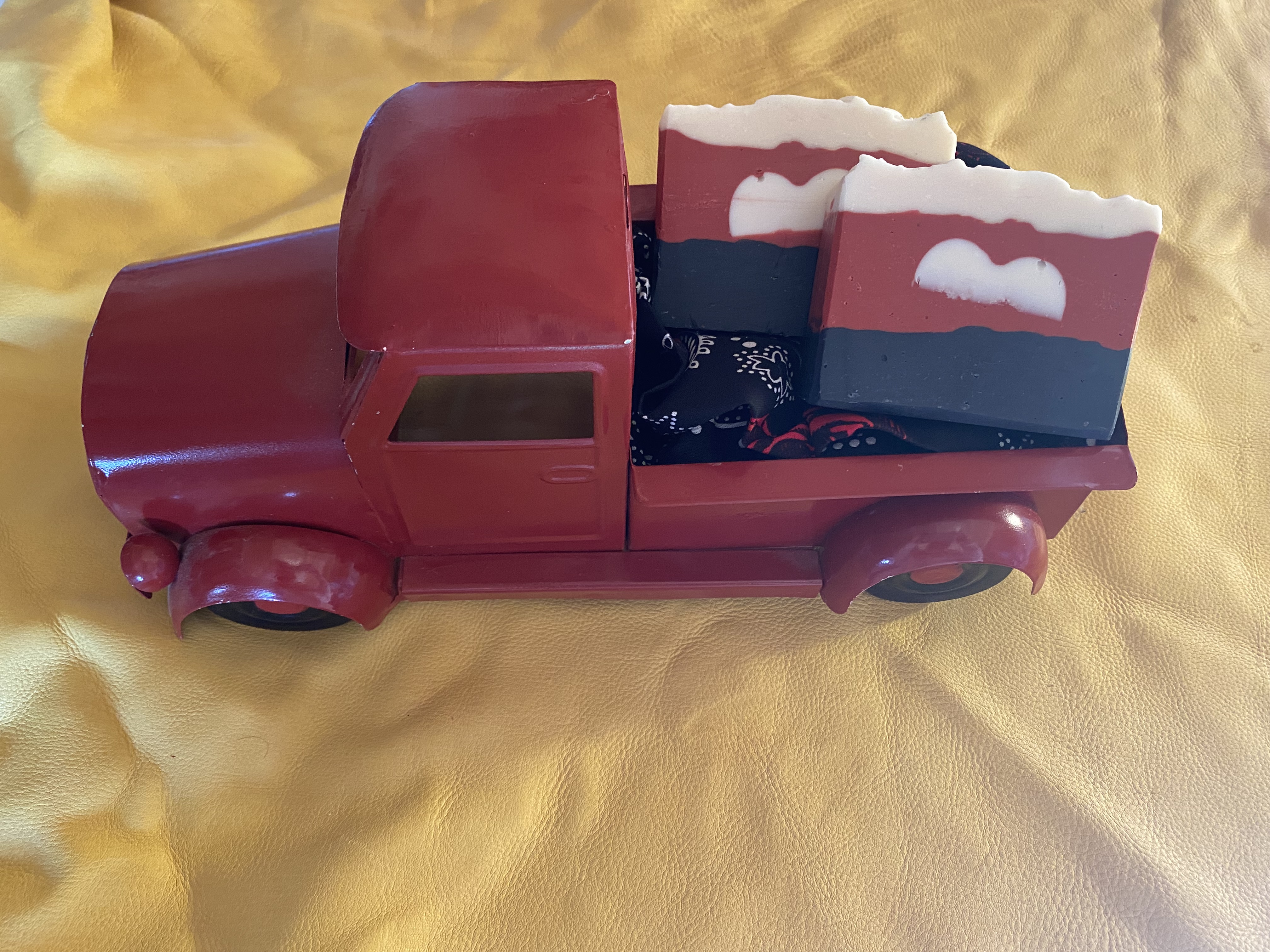 small red truck with soap in the bed of red pickup